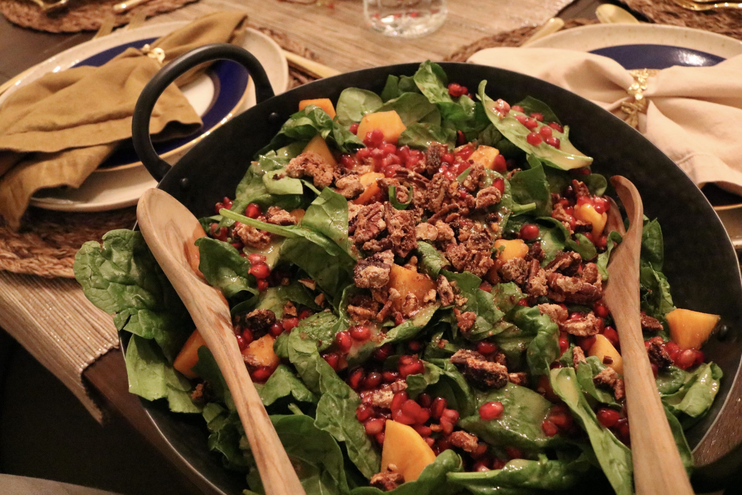 fall spinach salad with persimmons, pomegranate seeds, candied walnuts and a citrus walnut dressing